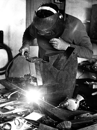 Richard Lacey at his studio, welding 1967 - photograph by James Soullier 